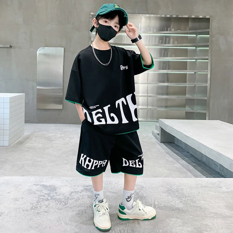 Child wearing a black outfit with 'DELT' and 'Kappa' branding in a modern indoor setting.