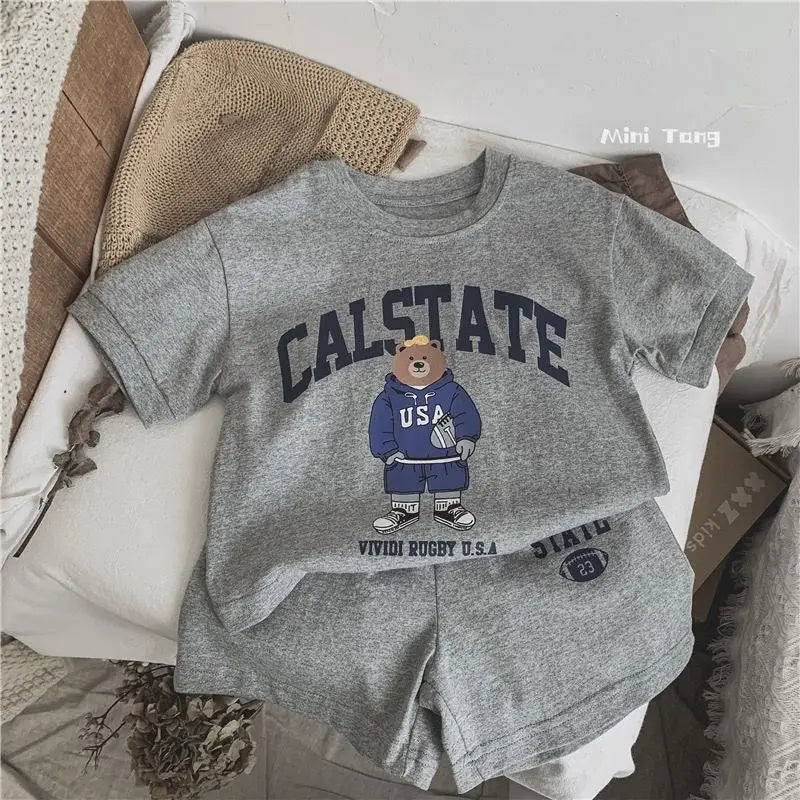 Gray 'Cal State' t-shirt and shorts set with bear graphic on a textured surface.