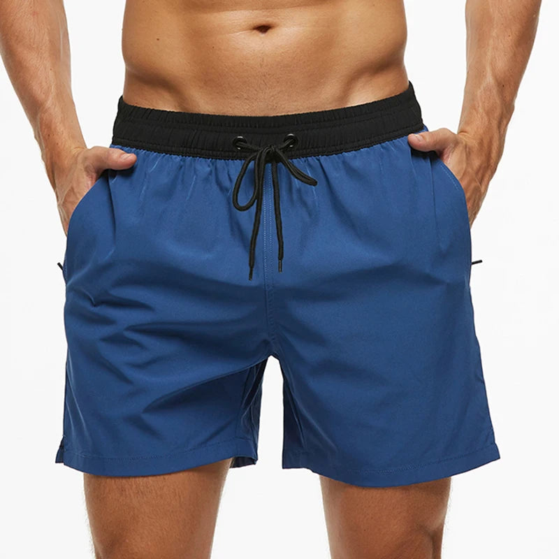 Blue swim shorts with a black waistband on a white background
