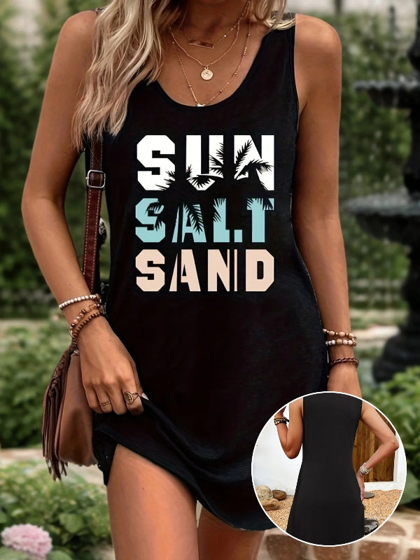 A sleeveless black tank top dress with text print 'SUN SALT SAND' on a woman standing outdoors, carrying a brown purse and wearing a watch.