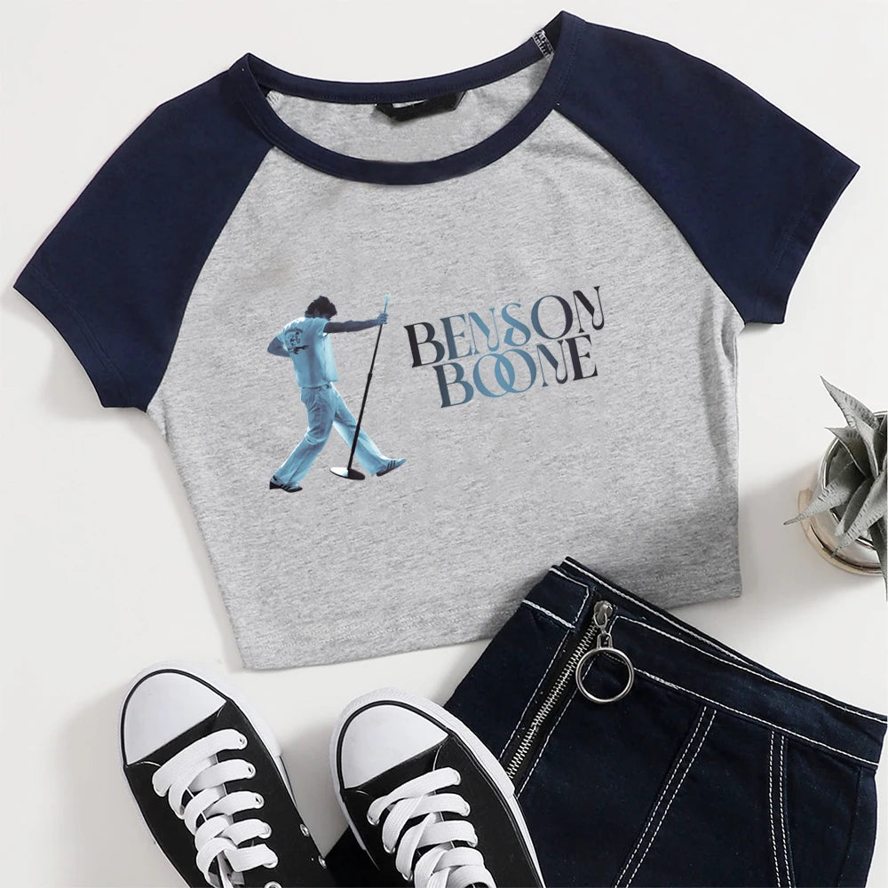 Gray and navy baseball shirt with golf graphic and 'Benson Boone' text, paired with black sneakers and a black bag.