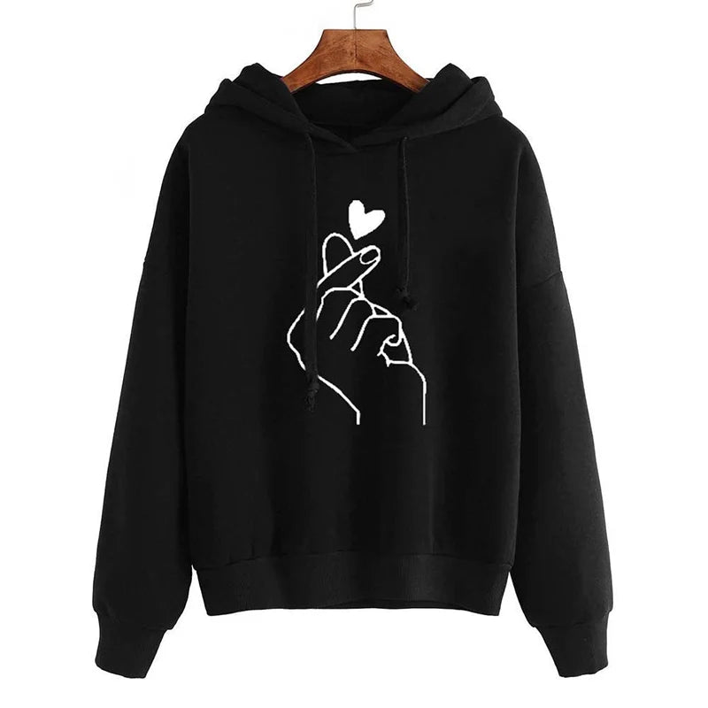 Black hoodie with a white hand gesture and heart design on a hanger against a white background