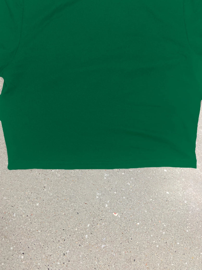 Green t-shirt on a gray surface