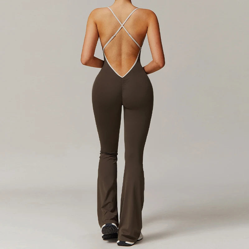 Woman wearing sleeveless V-back workout jumpsuit in a yoga pose with sporty background