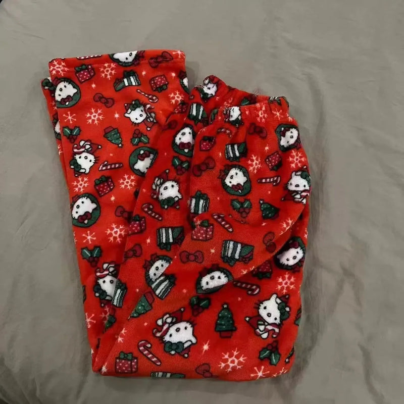 Folded red fabric with Christmas-themed designs on a gray surface