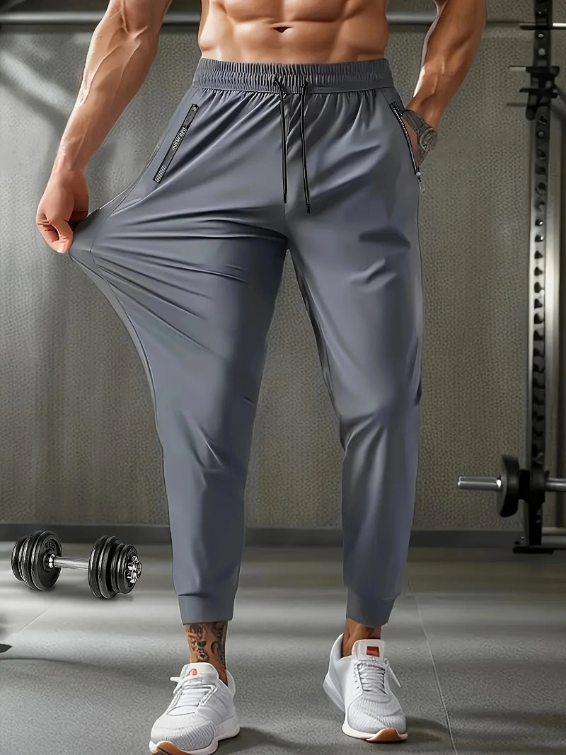 Person wearing gray athletic pants in a gym setting