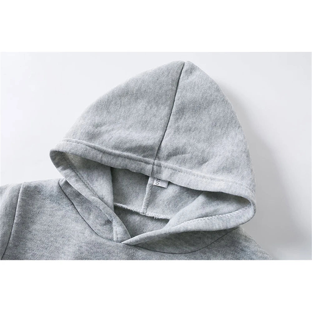 Gray hoodie with a brand tag on a light gray background