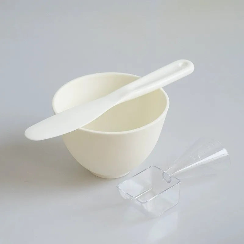 White bowl with a white spoon on a light gray background