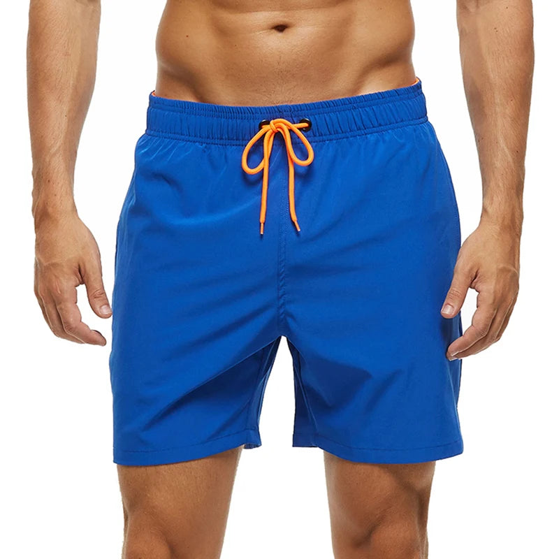 Blue swim shorts with orange drawstring on a white background