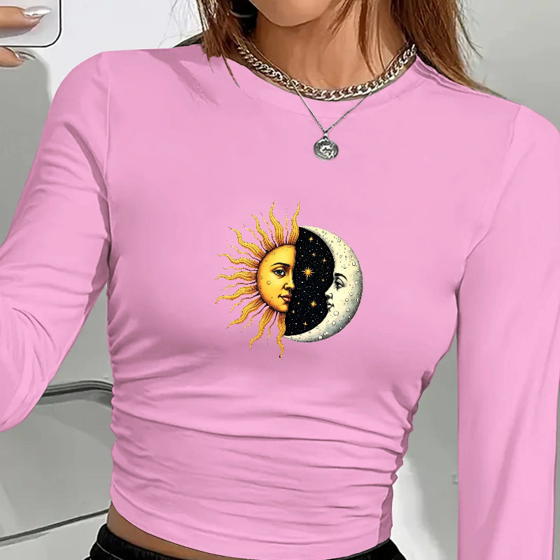 Pink long-sleeve shirt with sun and moon design worn by a person.