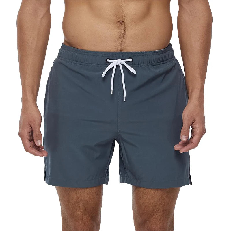 Blue swim shorts with a white drawstring on a white background
