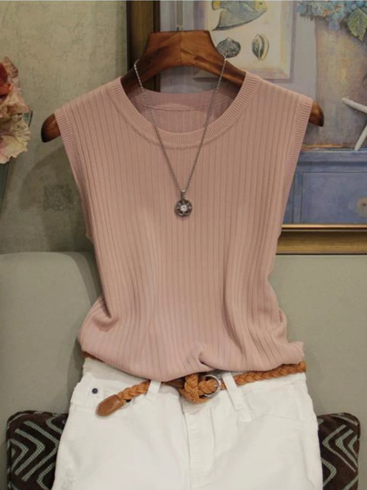 Pink ribbed tank top on a hanger with a neutral background