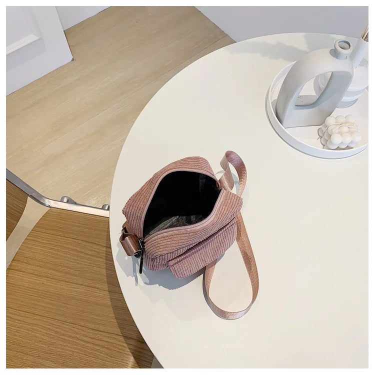 Striped corduroy fabric shoulder bag with zipper and crossbody strap, casual canvas tote for women inside pink