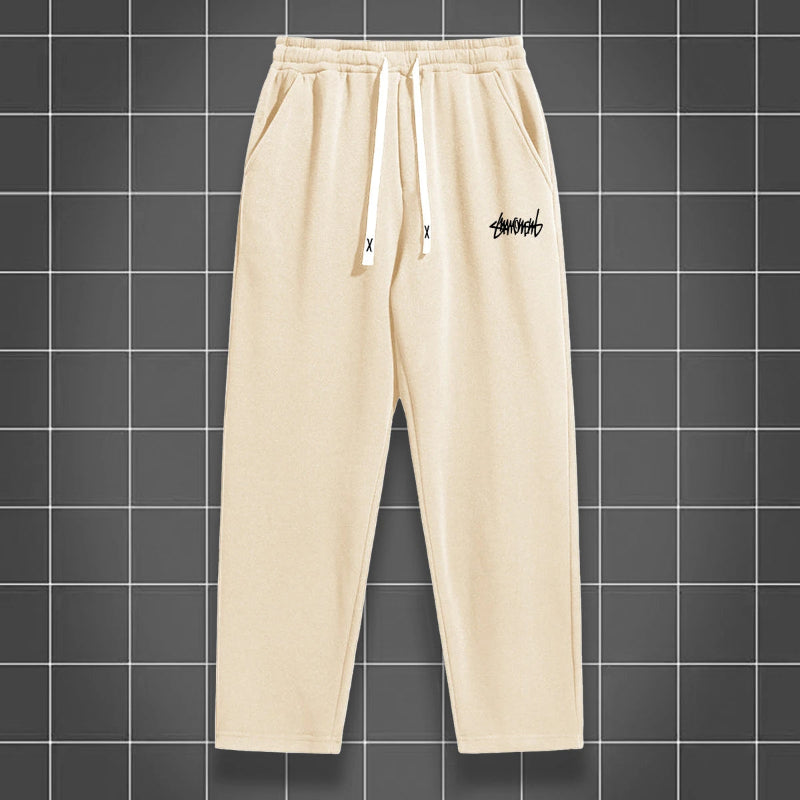 Beige sweatpants with a logo on a grid background
