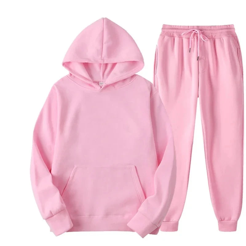 Pink hoodie and pants set on a white background