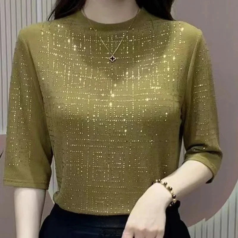 Green glittery top worn by a mannequin against a neutral background