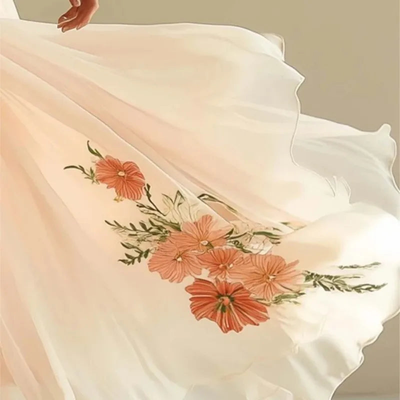 Light pink fabric with floral embroidery on a neutral background