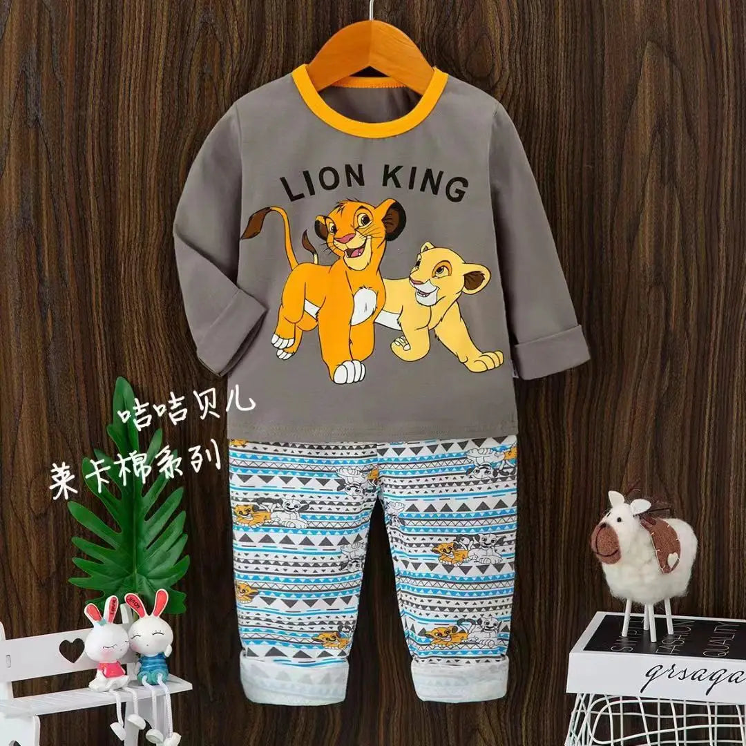 Children's outfit with 'Lion King' design on a wooden background
