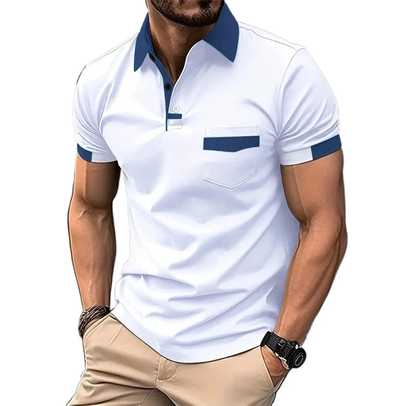A man wearing a short-sleeved beige polo shirt with blue collar and pocket trim, and light beige shorts.
