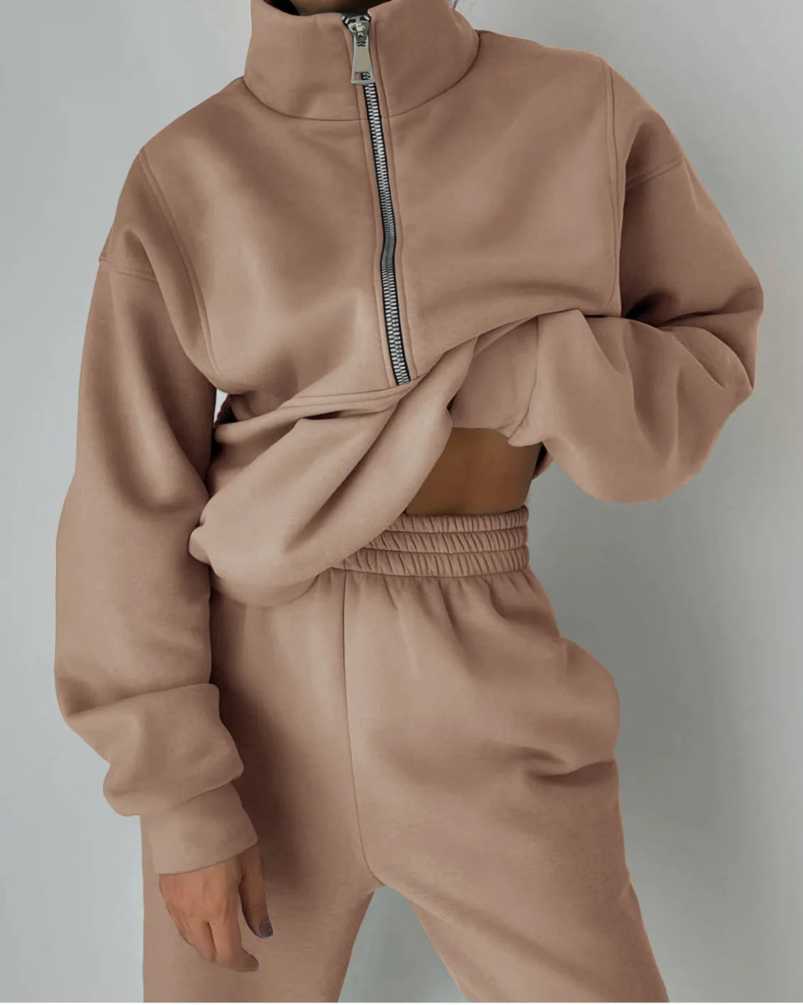 Beige tracksuit with a half-zip top on a gray background