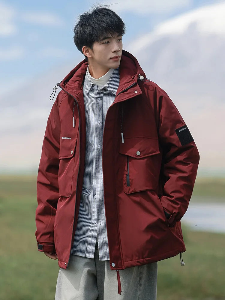 Person wearing a red jacket outdoors with a blurred natural background