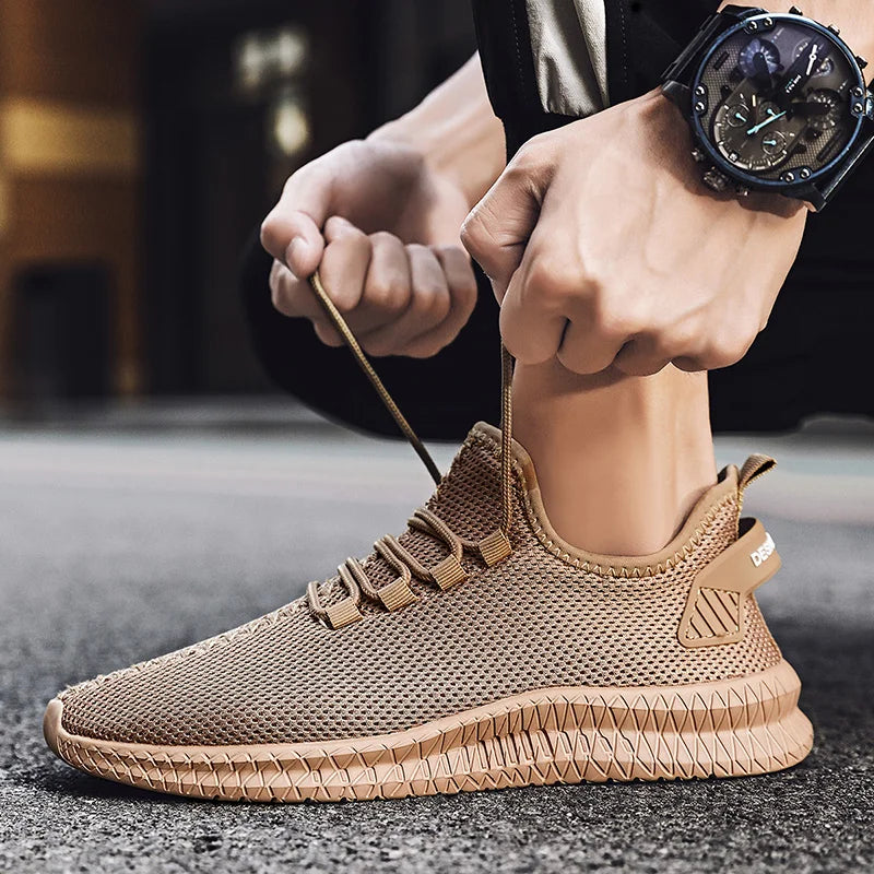 Person tying the laces of a brown sneaker on a blurred background