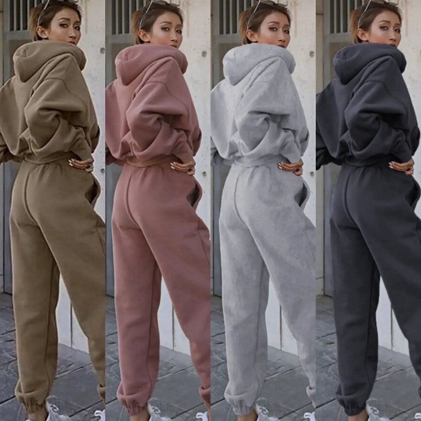 Four different colored tracksuits worn by a person, shown from behind.