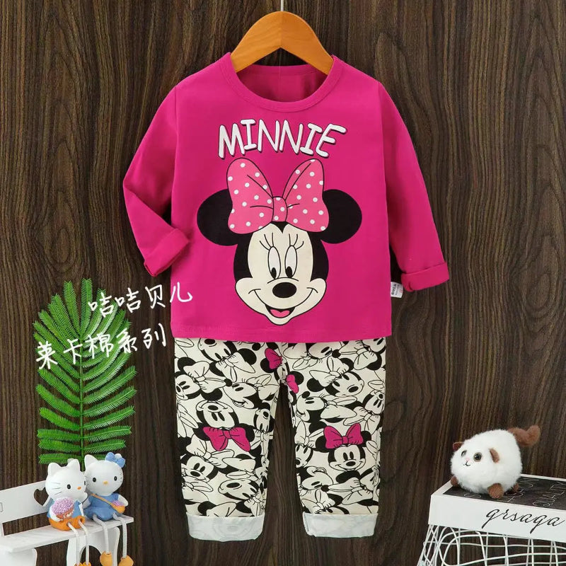 Children's outfit with Minnie Mouse design on a wooden background