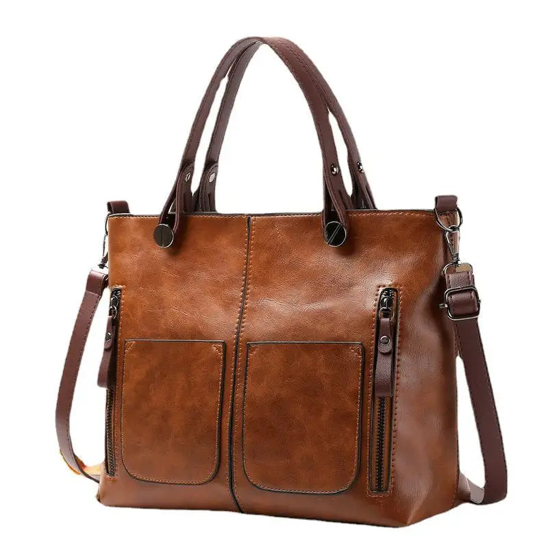 Brown leather handbag with multiple pockets and straps on a white background