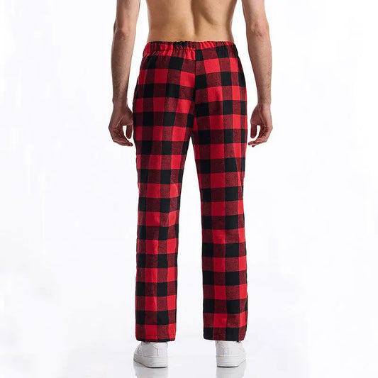 Red and black checkered pajama pants worn by a person on a white background