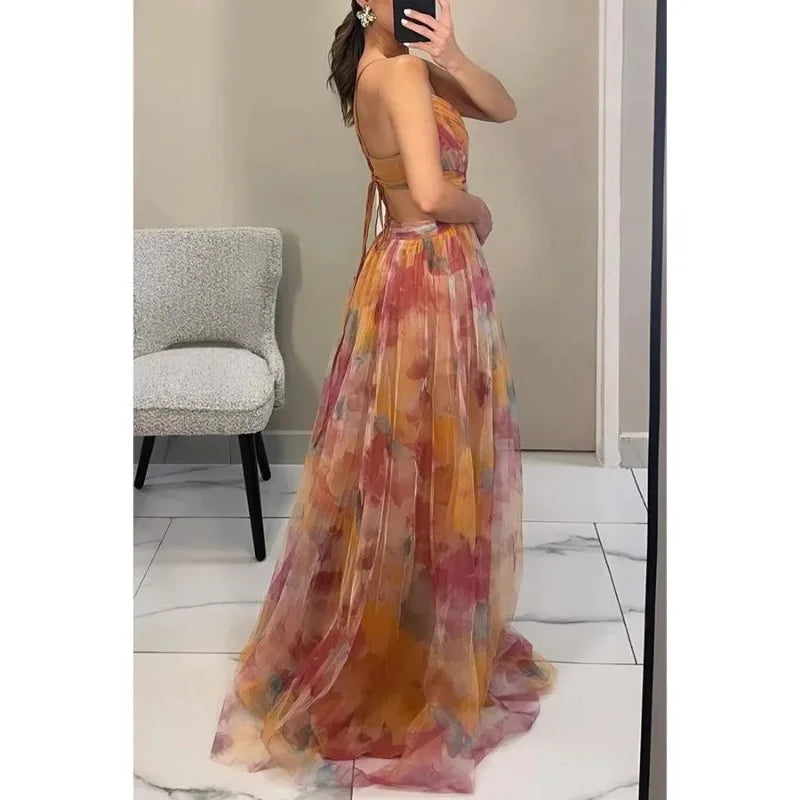 Woman wearing a floral dress taking a mirror selfie in a room.