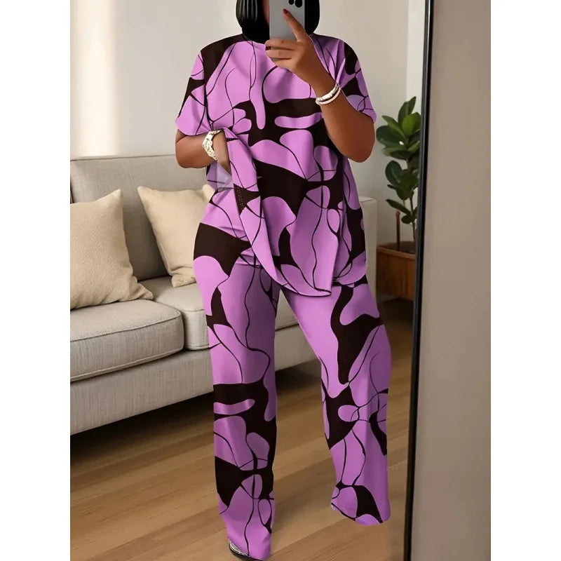 Person wearing a purple and black patterned outfit taking a mirror selfie in a living room.