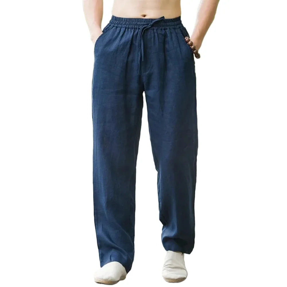 Blue linen pants worn by a person on a white background