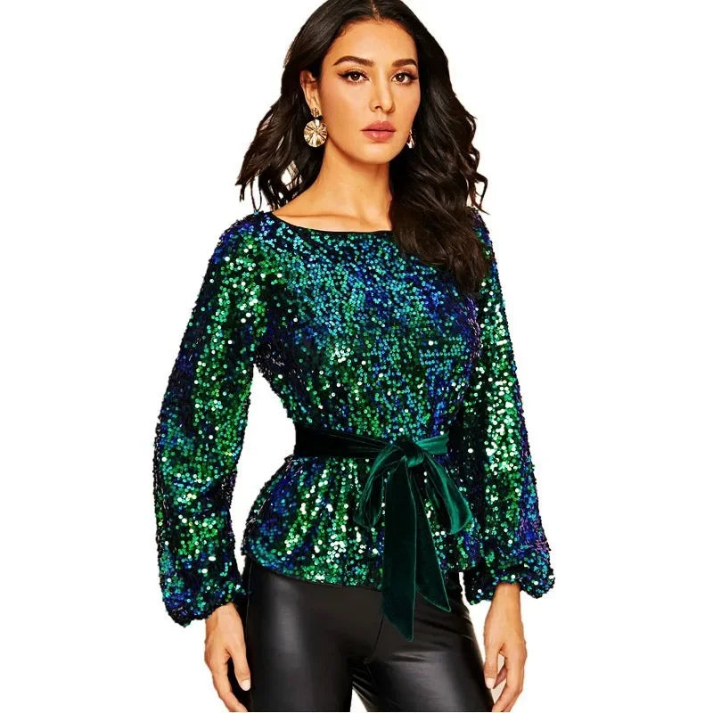 Woman wearing a green sequin top with a white background