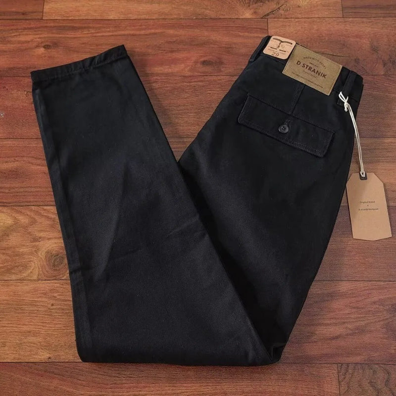 Black pants with tags on a wooden surface