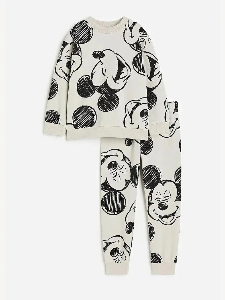 Children's pajama set with black and white cartoon character design on a white background