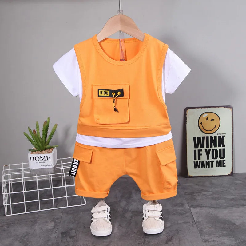 Children's outfit with orange vest and shorts on a hanger against a gray background.