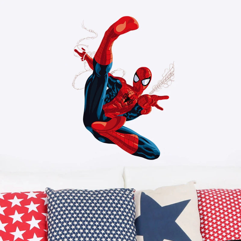 Spider-Man balloon in red and blue against a white background with star-patterned pillows below.