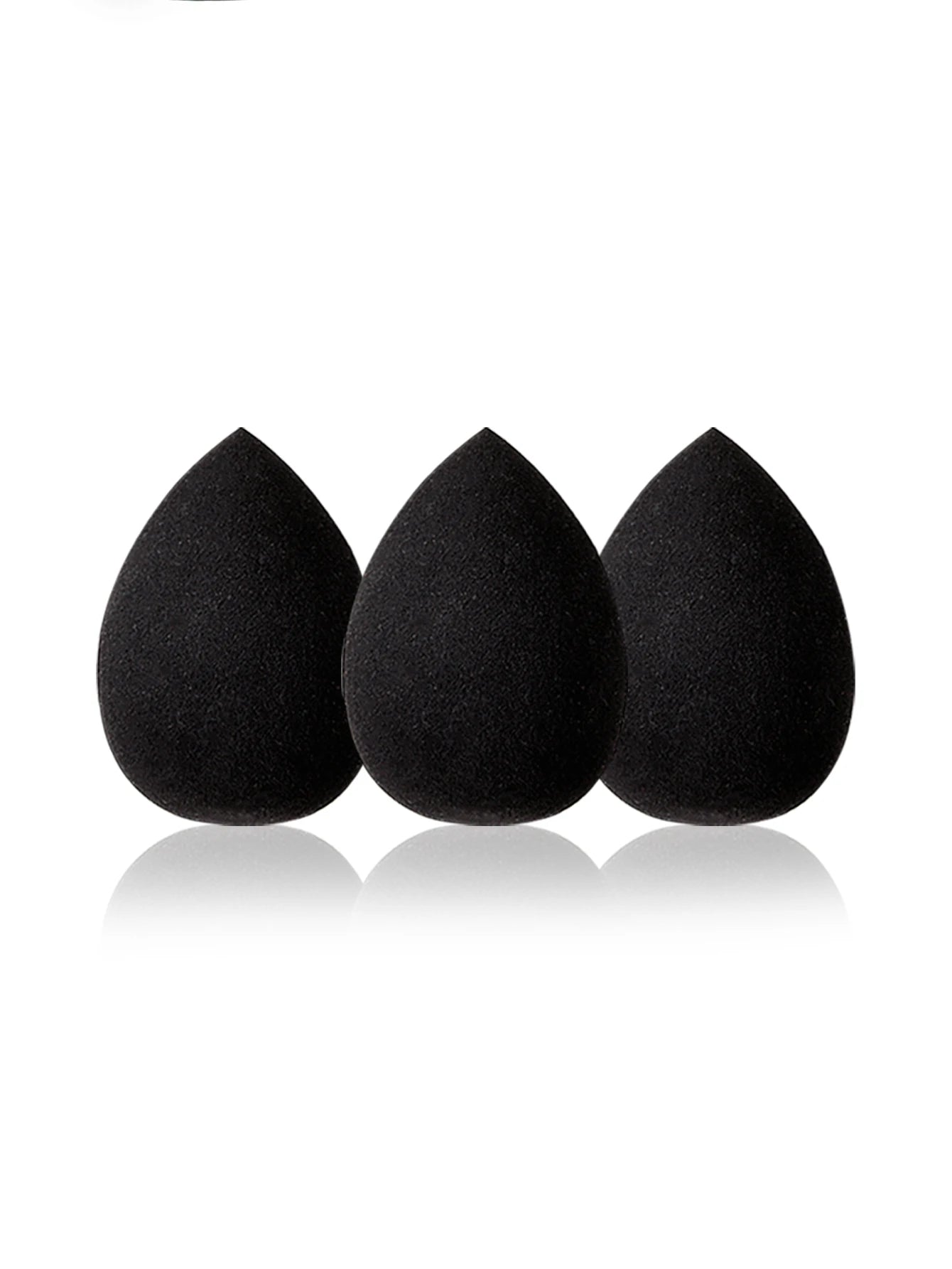 Three black makeup sponges on a white background