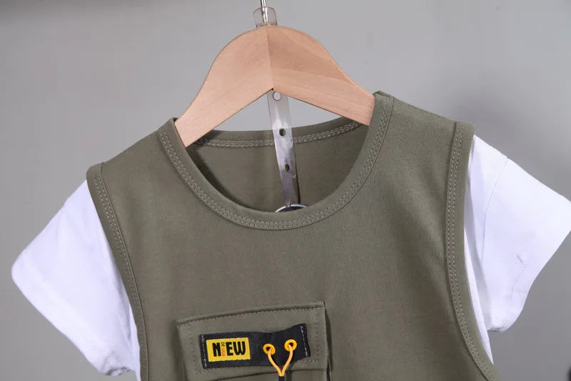Children's green vest with a yellow patch on a hanger against a gray background