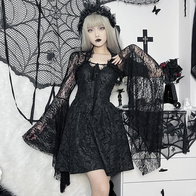 Person wearing a black lace dress in a gothic-themed setting with spider webs and crosses.