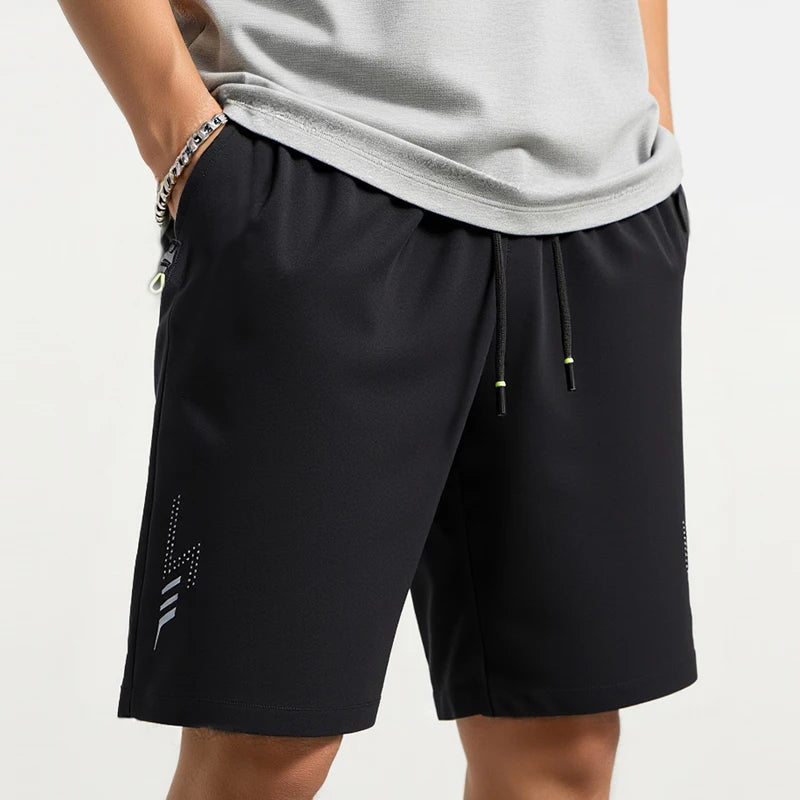Black athletic shorts with a gray shirt on a white background