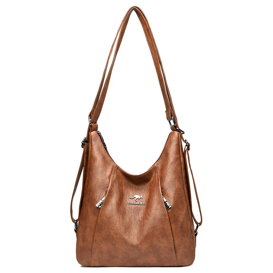 Brown leather handbag with shoulder strap on a white background