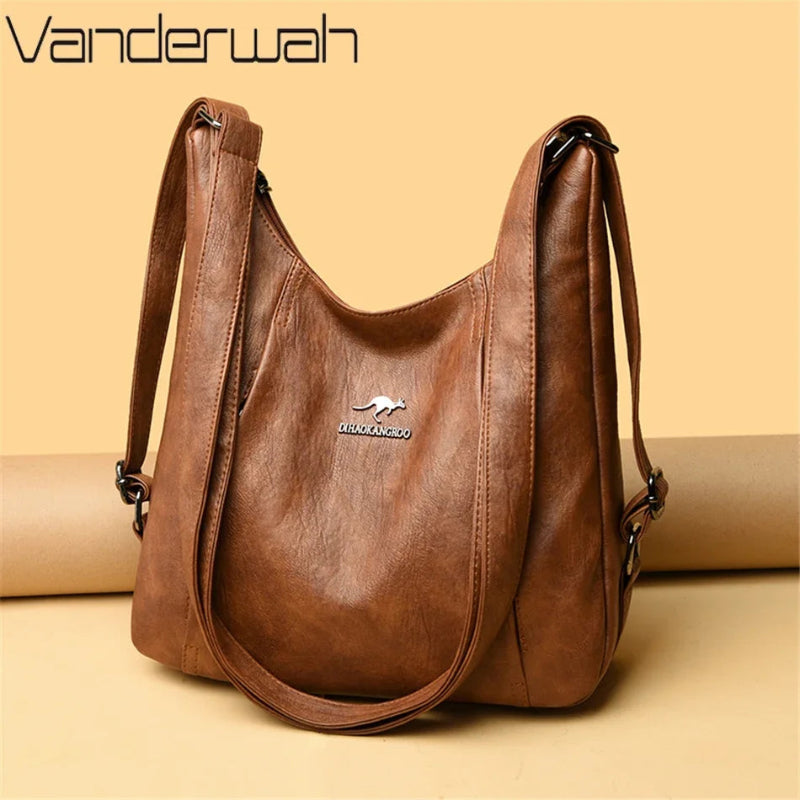 Brown leather handbag with visible brand logo on a beige background