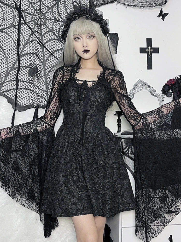 Person wearing a black lace dress in a gothic-style setting with crosses and spider webs.