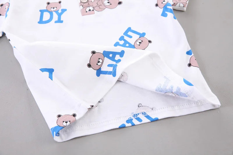 White fabric with cartoon bear designs and text on a gray background