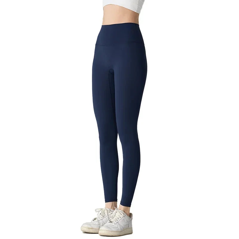 Navy blue leggings worn by a person on a white background