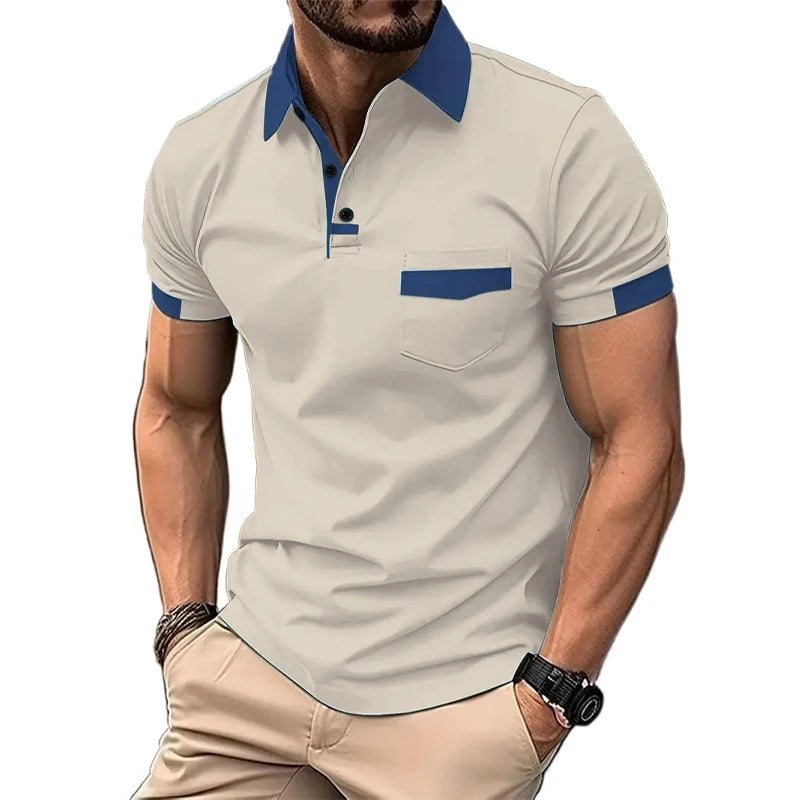 A man wearing a short-sleeved beige polo shirt with blue collar and pocket trim, and light beige shorts.