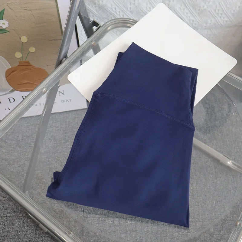 Navy blue sleeveless top on a glass table with a blurred background