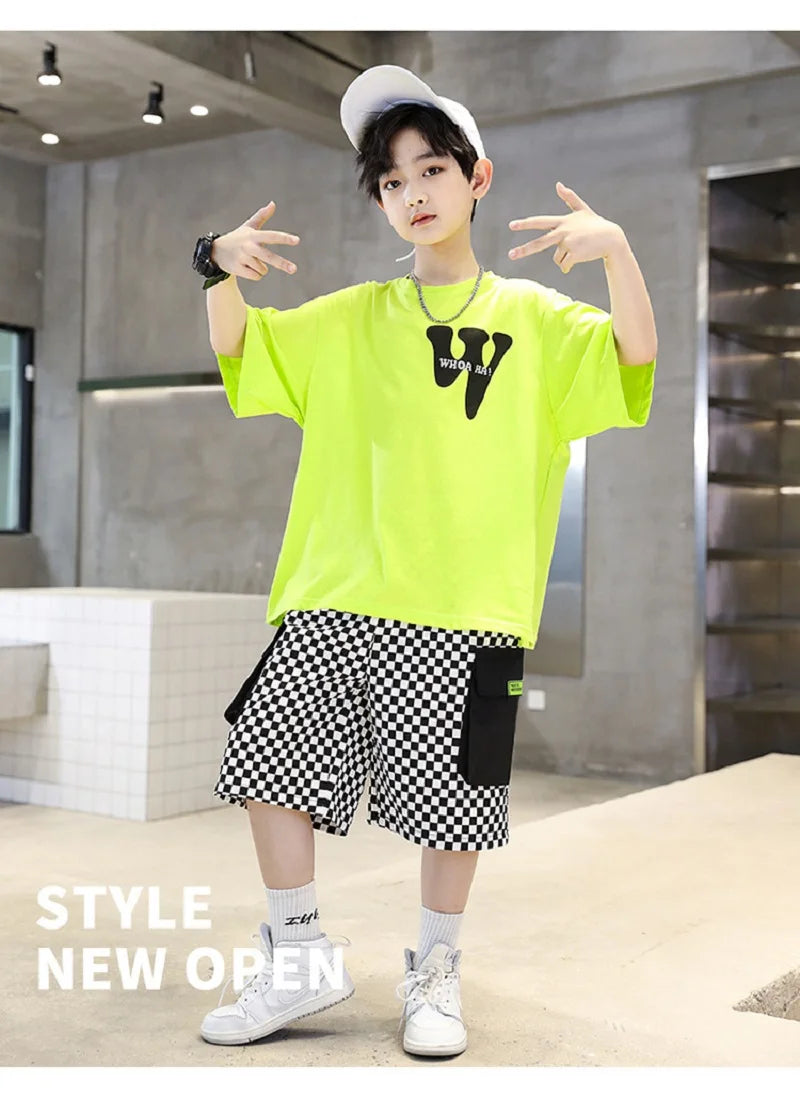 Person wearing a bright green shirt with a logo and checkered shorts in an indoor setting.